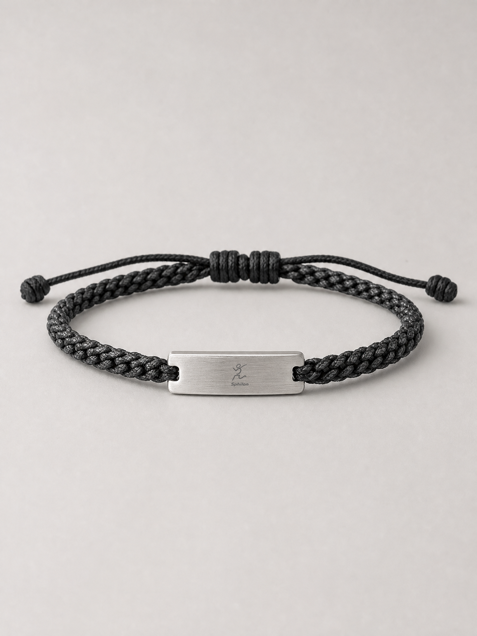 Braided Cord Bracelet — Braided nylon cord with silver metal identification plate